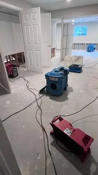 Air movers on the floor of an interior drying after water damage