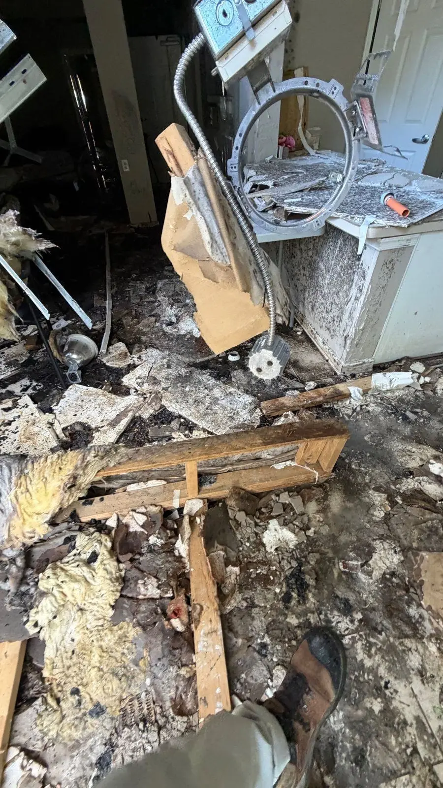 Fire-gutted interior covered in debris and ash