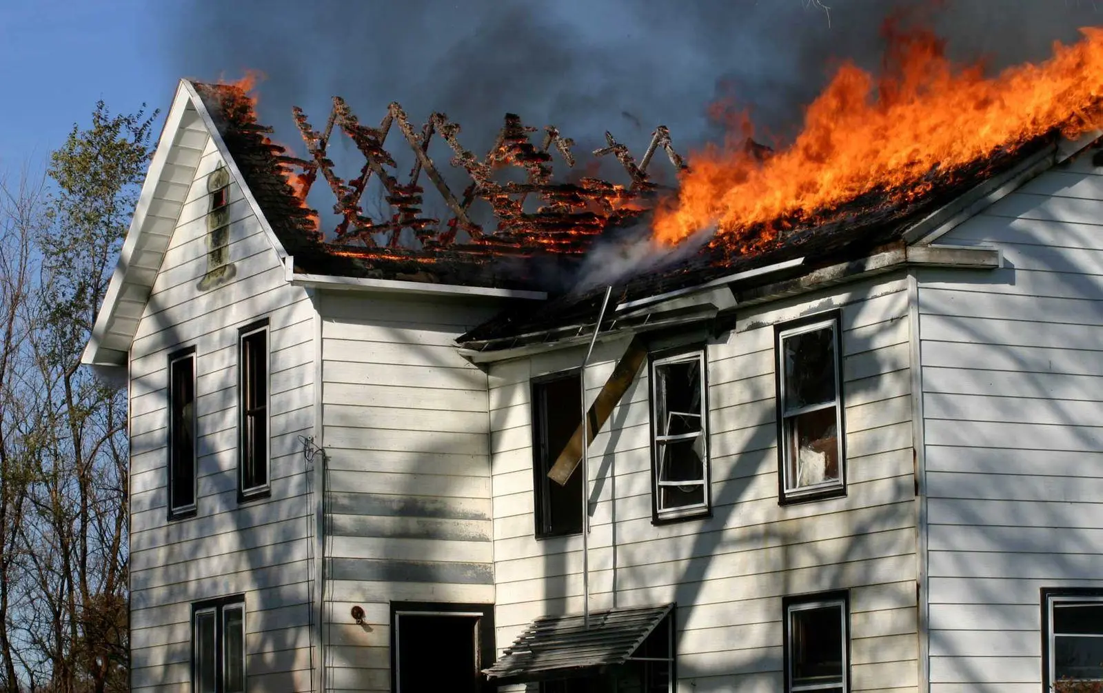 A house with flames spreading across its roof